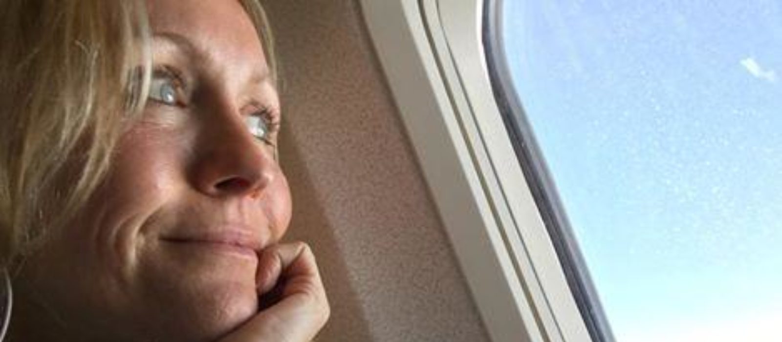 Miriam looking out the window of a plane